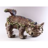 A CHINESE MOULDED POTTERY LION DOG, 48cm long.