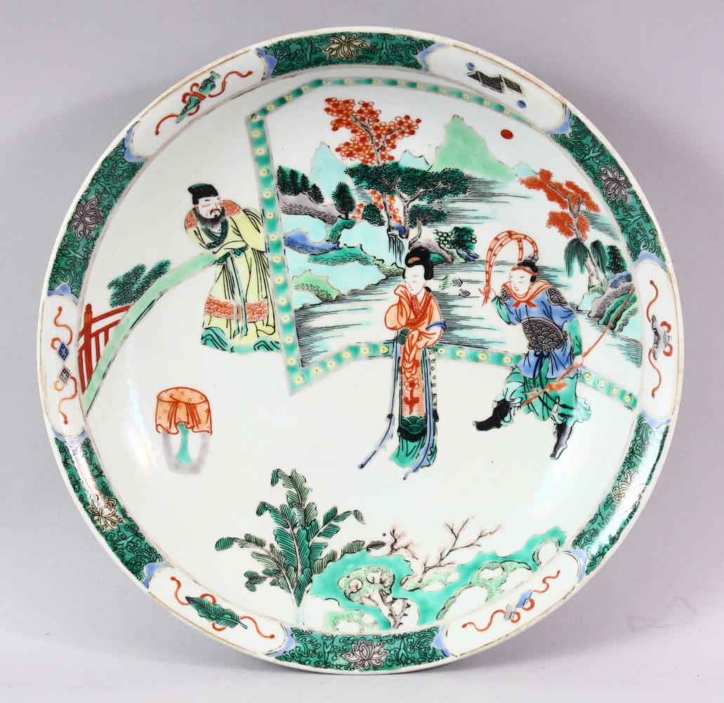 A CHINESE FAMILLE VERTE CIRCULAR PORCELAIN DISH, painted with figures in a garden setting, Kangxi
