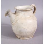 AN EARLY CHINESE POTTERY JUG, with floral decoration, 11cm high.