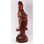A GOOD LARGE CHINESE CARVED WOOD FIGURE OF GUANYIN, standing on a dragon, 55cm high.