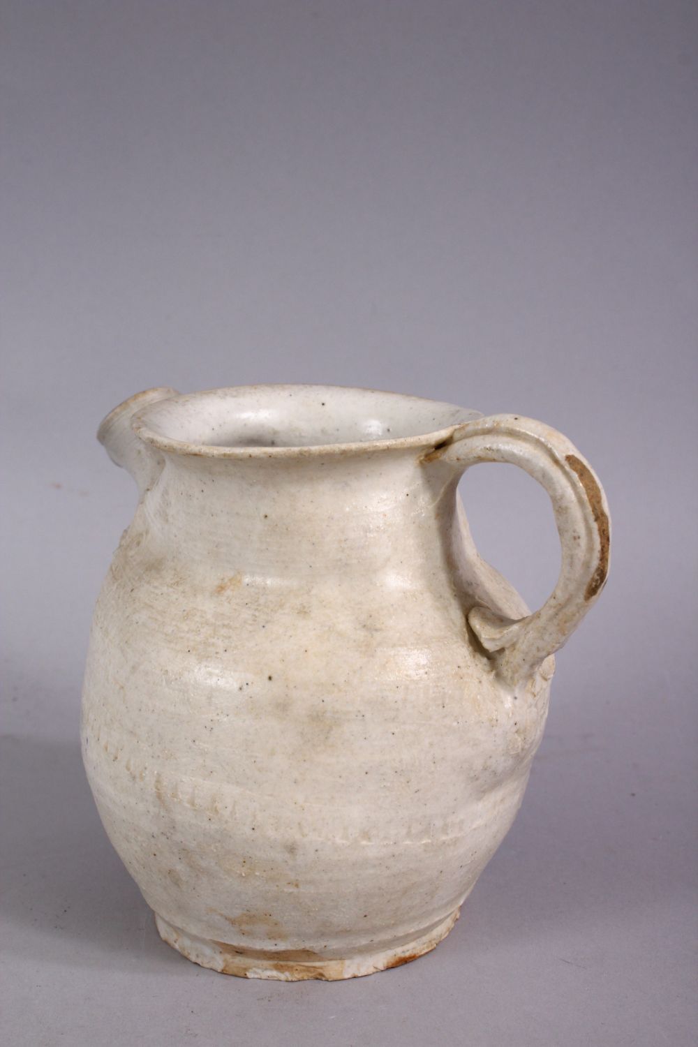 AN EARLY CHINESE POTTERY JUG, with floral decoration, 11cm high. - Image 2 of 4