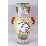 A GOOD LARGE FAMILLE ROSE BALUSTER SHAPE VASE, with coral coloured elephant head handles, painted