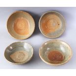 A GROUP OF FOUR EARLY CHINESE EARTHENWARE CIRCULAR BOWLS, various sizes.