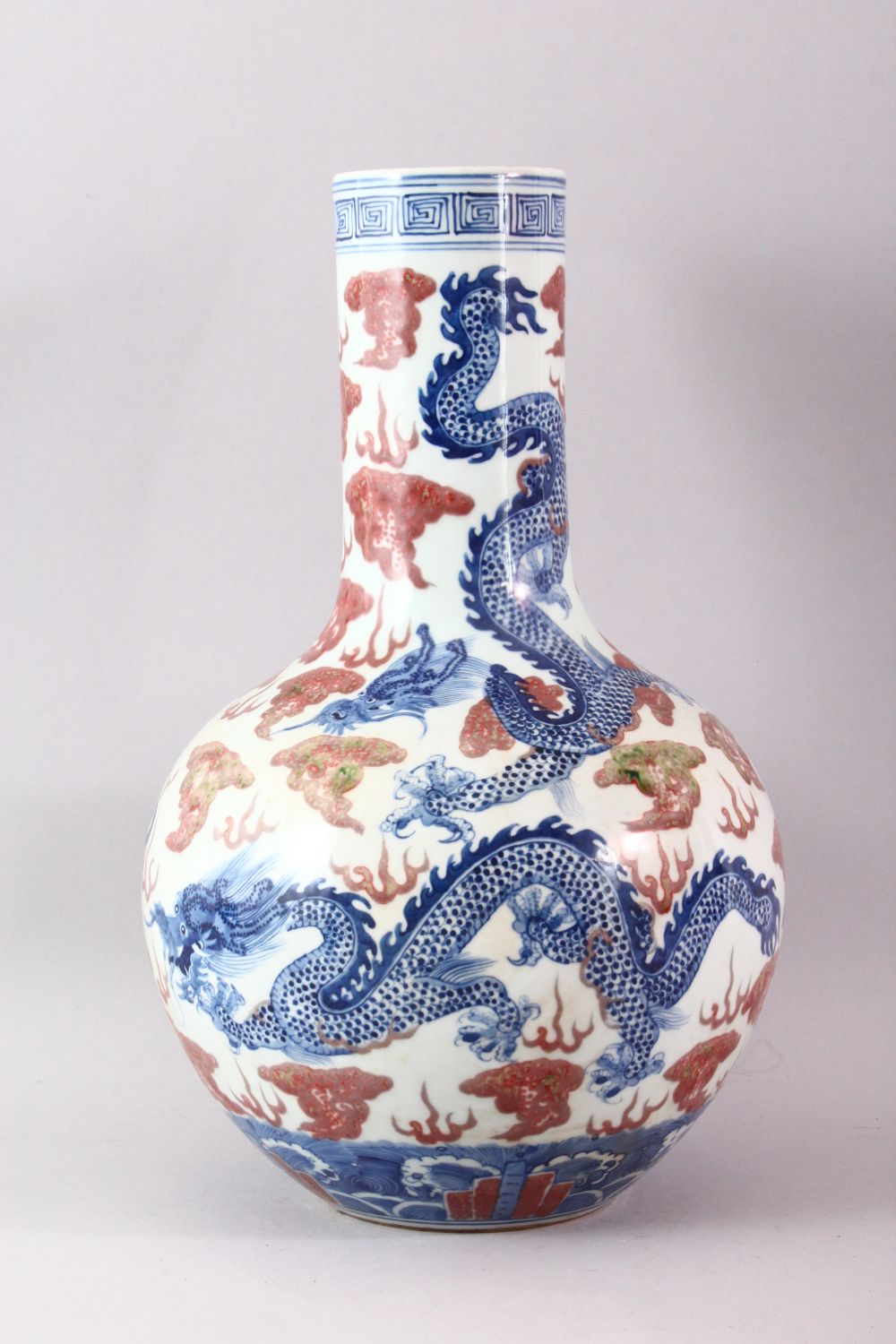 A LARGE UNDERGLAZED BLUE AND COPPER RED DRAGON VASE, painted with dragons amongst clouds, six - Image 3 of 6