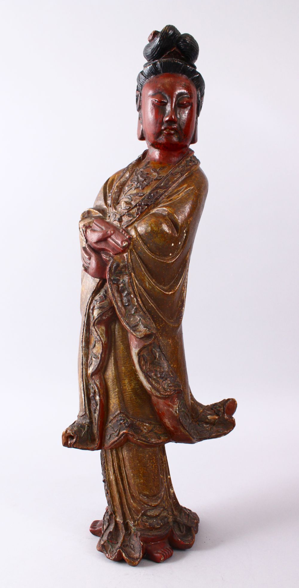 A LARGE 19TH CENTURY CHINESE CARVED AND LACQUERED WOODEN FIGURE OF GUANYIN, with carved wave