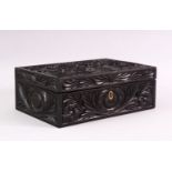 A CEYLONESE CARVED EBONY CASKET, with hinged lid, 26cm long.