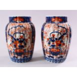 A PAIR OF JAPANESE MEIJI PERIOD IMARI PORCELAIN VASES, decorated with panels of ikebana and