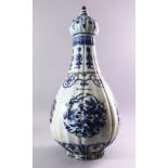 A LARGE KANGXI STYLE RIBBED PEAR-SHAPED BOTTLE VASE AND COVER, painted with panels of dragons,