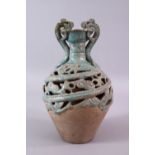 A CHINESE TANG STYLE CELEDON GLAZED DOUBLE WALLED BOTTLE VASE, with dragon handles, 27cm.