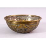 A SMALL ISLAMIC CIRCULAR BRASS BOWL with silver inlaid and engraved decoration, 13cm diameter.