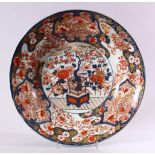 A JAPANESE EDO / MEIJI PERIOD IMARI PORCELAIN CHARGER, decorated with scenes of ikebana displays