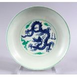 A CHINESE FAMILLE VERTE / DOUCAI PORCELAIN DRAGON DISH, with a five claw dragon amongst clouds,