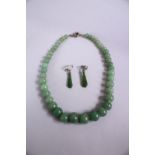 A JADE BEAD NECKLACE, and a pair of jade earrings.