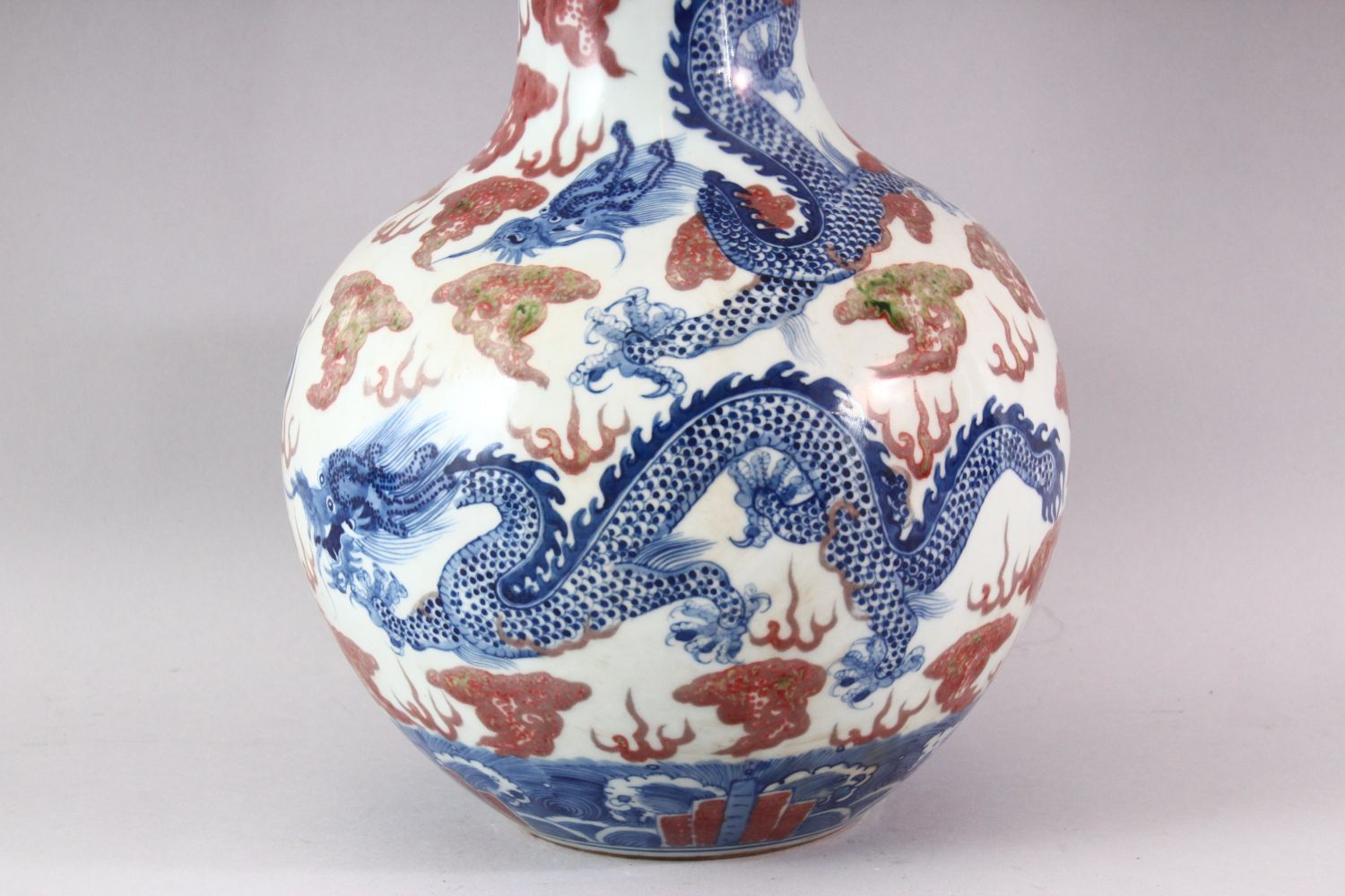 A LARGE UNDERGLAZED BLUE AND COPPER RED DRAGON VASE, painted with dragons amongst clouds, six - Image 4 of 6