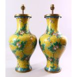 A PAIR OF CHINESE CLOISONNE VASES, with yellow ground and lotus flowers, converted into lamps,