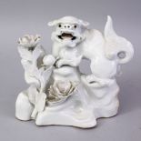 A JAPANESE MEIJI PERIOD HIRADO PORCELAIN SHI SHI DOG FIGURE, blanc de chine style, stood upon a