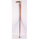 A LATE 19TH CENTURY RHINO HANDLED WALKING STICK, with engraved silver collar, 84cm long.