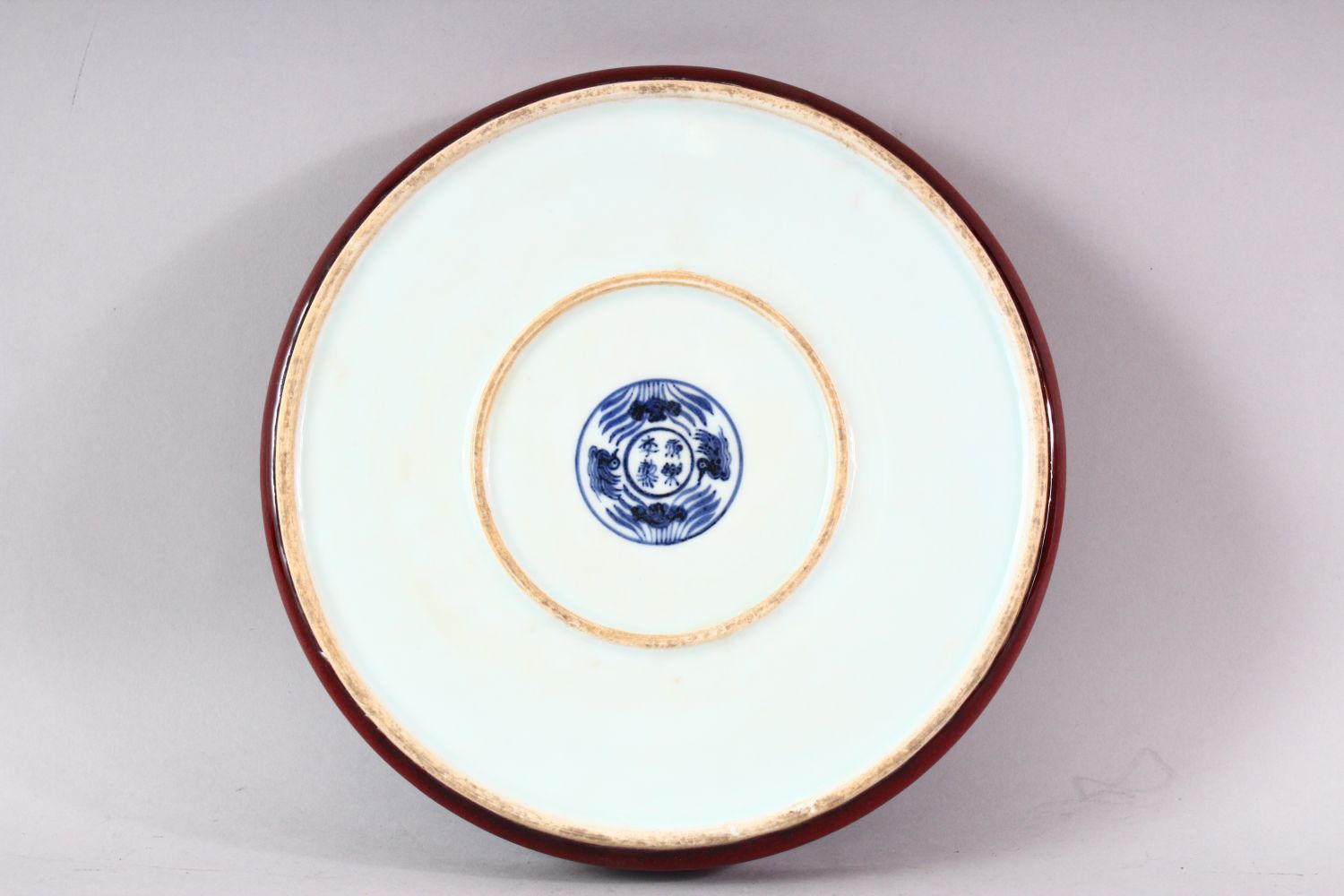 A MING STYLE COPPER RED CIRCULAR PORCELAIN DISH, the central blue and white panel painted with lotus - Image 4 of 5