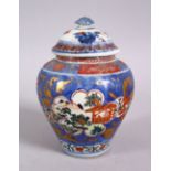 AN 18TH CENTURY JAPANESE BLUE, WHITE AND IRON RED PORCELAIN ARITA JAR & COVER, with landscape