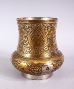 A SMALL INDIAN ENGRAVED BRASS AND WHITE METAL CIRCULAR VASE, 11cm high.