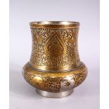 A SMALL INDIAN ENGRAVED BRASS AND WHITE METAL CIRCULAR VASE, 11cm high.