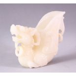 A 20TH CENTURY CHINESE CARVED WHITE JADE LIBATION CUP OF A LION DOG, 14cm high.