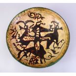 A GOOD EARLY ISLAMIC POTTERY DISH, decorated with animals (AF), 33cm,