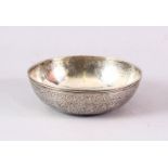 A SMALL PERSIAN SILVER CIRCULAR BOWL, with engraved decoration, 11cm diameter.