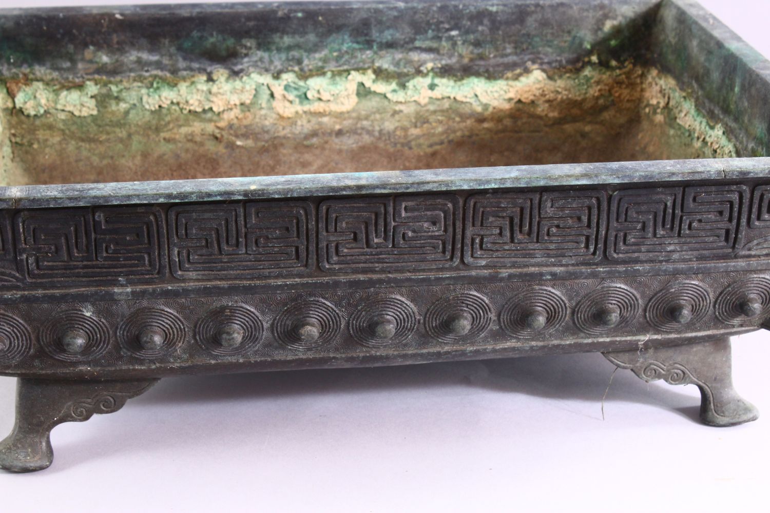 A CAST BRONZE RECTANGULAR BONSAI PLANTER, cast a key border and shield shaped motifs on curving - Image 3 of 4