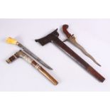 TWO SOUTH ASIAN KRIS DAGGERS - one with a bone handle with a wooden and white metal sheath, 35.5cm ,