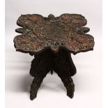 A GOOD EARLY 20TH CENTURY BURMESE HARDWOOD TABLE, the shaped top and folding base, profusely