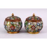 A PAIR OF CHINESE CLOISONNE LIDDED JARS, each decorated with raised floral decoration, 9cm high x
