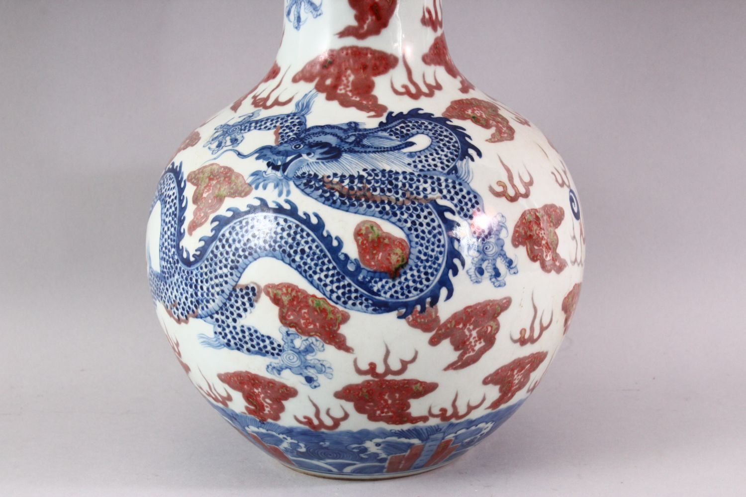 A LARGE UNDERGLAZED BLUE AND COPPER RED DRAGON VASE, painted with dragons amongst clouds, six - Image 2 of 6