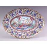 AN INDIAN ENAMELLED COPPER DISH of lobed oval form, the centre painted with a courting couple and