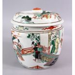A CHINESE FAMILLE VERTE PORCELAIN JAR AND COVER, decorated with scenes of figures in a balcony
