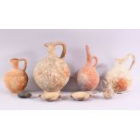 A SMALL COLLECTION OF EXCAVATED POTTERY ITEMS, comprising four teracotta jugs, two small twin handle