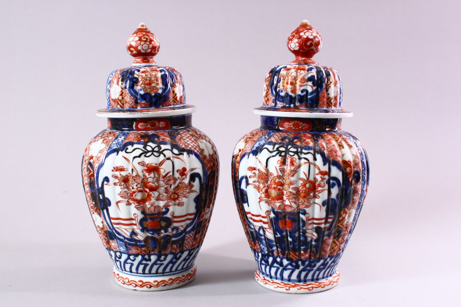 A PAIR OF JAPANESE MEIJI PERIOD IMARI PORCELAIN VASES & COVERS, with panel decoration depicting - Image 3 of 6