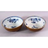 A PAIR OF CHINESE NANKING CARGO SHIPWRECK BOWLS, the interior with blue and white floral decoration,