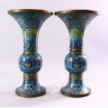 A GOOD PAIR OF 19TH CENTURY CHINESE CLOISONNE GU FORM VASES, on pale blue ground with stylised