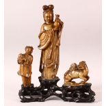 A GOOD 18TH / 19TH CENTURY CHINESE SOAPSTONE GROUP, the central female figure holding an urn, a