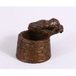 A JAPANESE BRONZE FIGURE OF A TOAD OVER A WELL, with carved calligraphy to the toad base, the