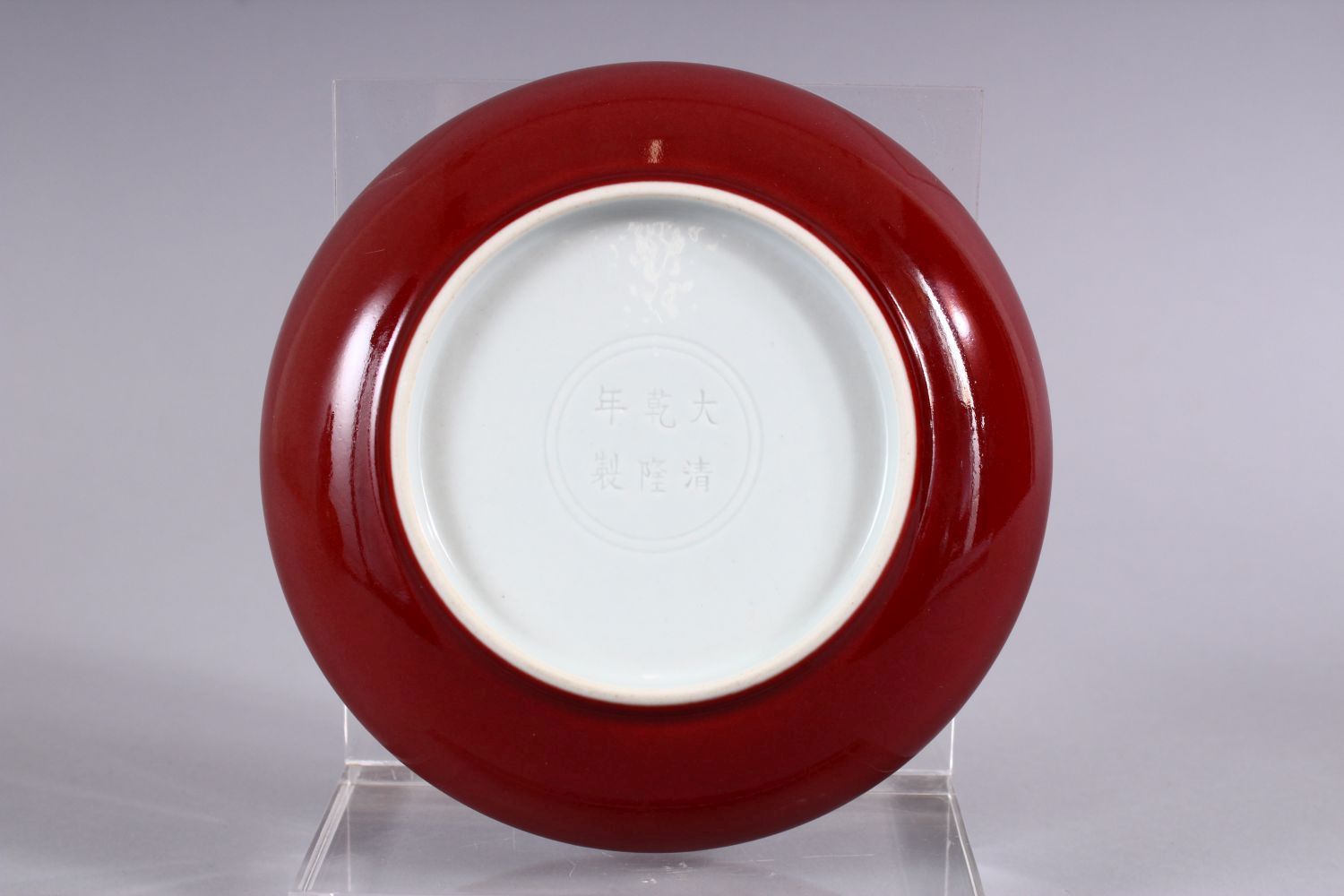 A CHINESE COPPER RED GLAZED PORCELAIN DISH, the base with incised double rings around a six - Image 2 of 3