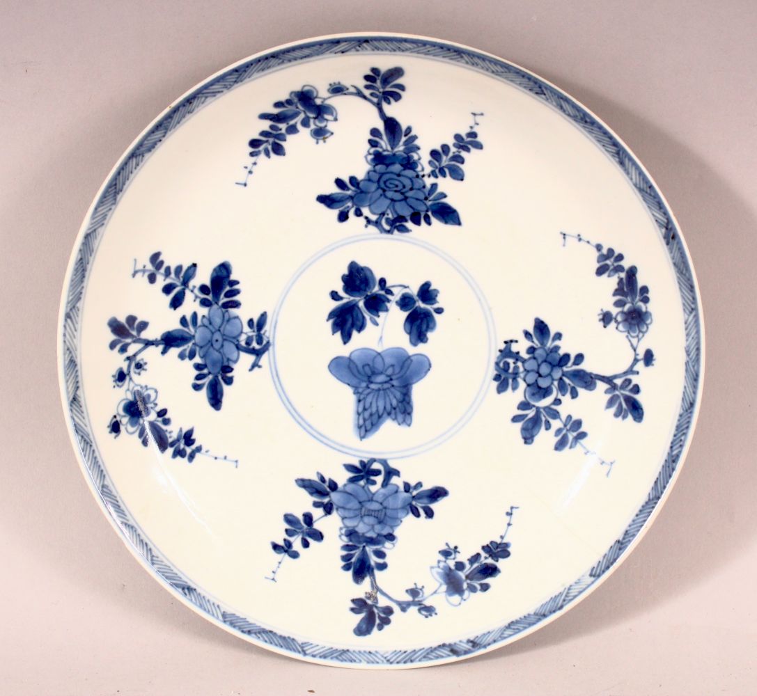 A CHINESE KANGXI BLUE AND WHITE PORCELAIN PLATE, painted with panels of flowers within a