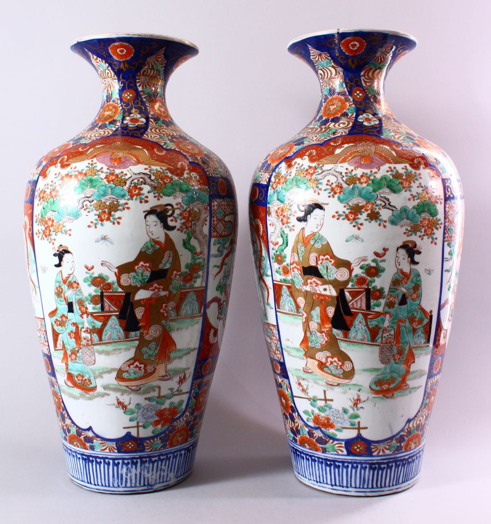 A LARGE PAIR OF JAPANESE MEIJI PERIOD IMARI PORCELAIN VASES, with panel decoration depicting figures