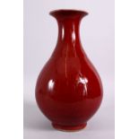 A CHINESE OX BLOOD RED YUHUCHUNPIN PORCELAIN VASE, with a ox blood red ground and a flared rim,