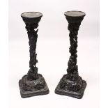 A PAIR OF 19TH CENTURY CARVED WOODEN DRAGON STANDS, the centres carved with intertwined dragons down