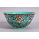 A CHINESE FAMMILE ROSE TURQUOISE GROUND LOTUS PORCELAIN BOWL, decorated with formal scrolling