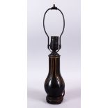 AN AFRICAN CARVED WOODEN LAMP VASE, the inner shaking like a maraca, 40cm high.