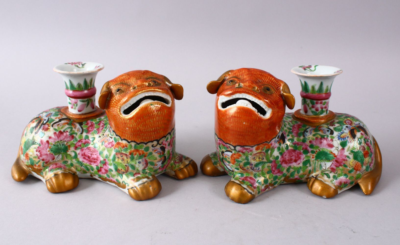 A GOOD PAIR OF 19TH CENTURY CHINESE CORAL & FAMILLE ROSE PORCELAIN CANDLESTICKS IN THE FORM OF