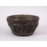 AN EARLY SUMERIAN POTTERY RAM BOWL, with relief carved rams, 13cm